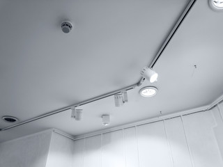 bright spotlights on exhibition hall. row of halogen lights in an office interior