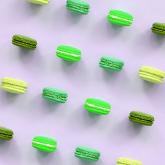 Dessert cake macaron or macaroon on trendy pastel lilac background top view