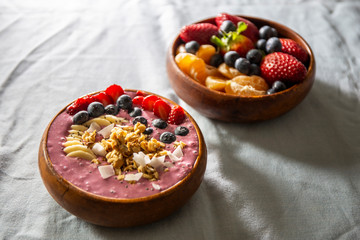 Smoothie bowl with fruits in wooden bowl