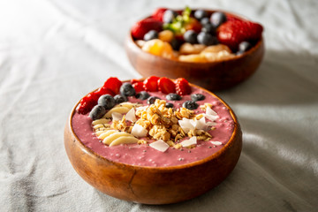 Smoothie bowl with fruits in wooden bowl