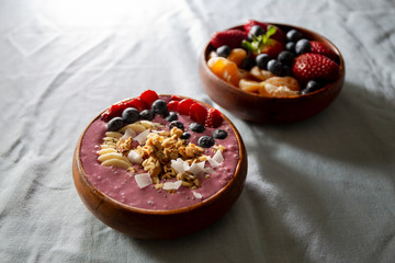 Smoothie bowl with fruits in wooden bowl