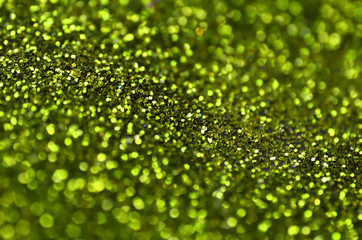 Lime green decorative sequins. Background image with shiny bokeh lights from small elements