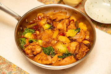 Spicy chicken stir-fry with sweet noodles.