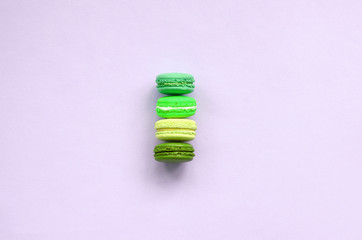 Dessert cake macaron or macaroon on trendy pastel lilac background top view