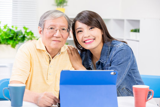 Daughter teach father use tablet