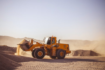 Bulldozers and earthmovers working in quarries