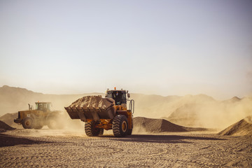 Bulldozers and earthmovers working in quarries