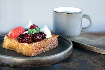 Delicious dessert with cream ,sorbet and blackberry and coffee cup