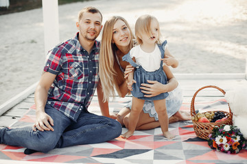 Fototapeta premium Family in a summer park. Mother and little daughter playing. Cute little girl with a father
