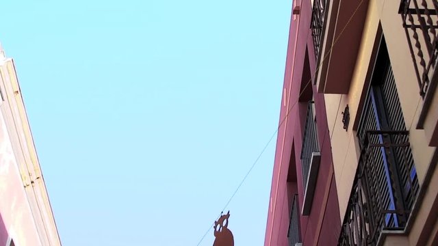 Party decoration hanging in the street between buildings.