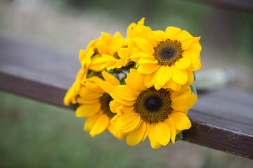 Sunflower bouquet on a wooden old bench