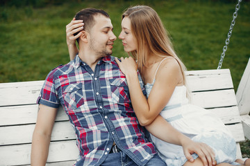 Couple in a park. Woman in a white dress. Man with his wife