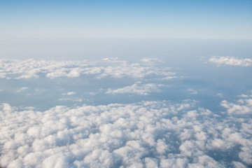 Fototapeta na wymiar Blue sky with clouds background. View from airplane