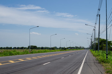 Fototapeta premium Asphalt road with electric pole in rural Thailand