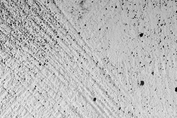 Neutral black and white background - a cut of white porous material, with traces of saws