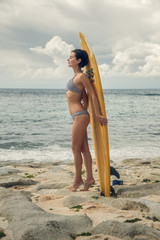 Girl with a surfboard. The girl on the beach. Bali. Journey. Travel.	