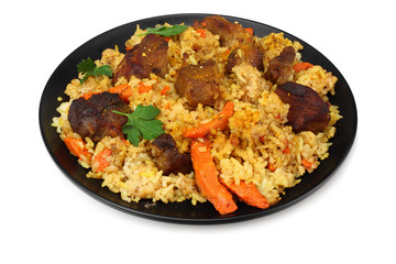 pilaf with meat on black plate isolated on white background