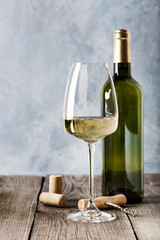 White wine in a glass and a bottle of white wine