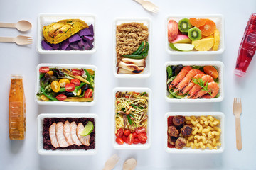 Prepared meal delivery concept. Top view of assorted ready-to-eat dishes over white background. Healthy eating. 
