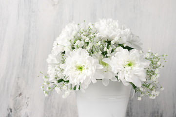 White flowers bouquet in bucket