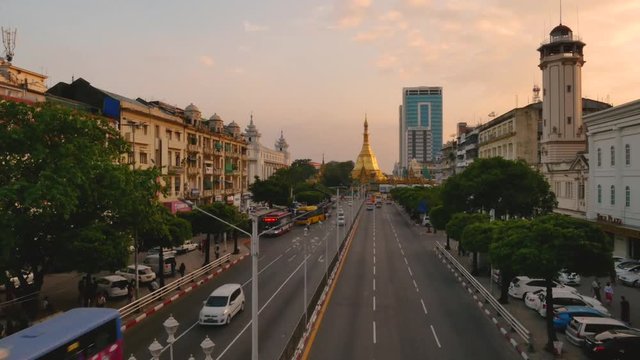 Streets of downtown Yangon on the road to Sule Pagoda time lapse with traffic jam and modern city