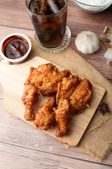 Hot and spicy Korean barbeque fried chicken on wood cutting board
