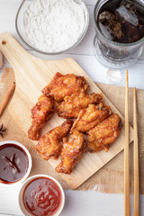 Hot and spicy Korean barbeque fried chicken on wood cutting board
