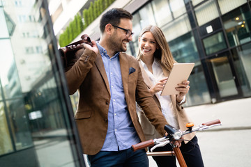 Naklejka premium Happy business colleagues talking and walking in the city outdoor