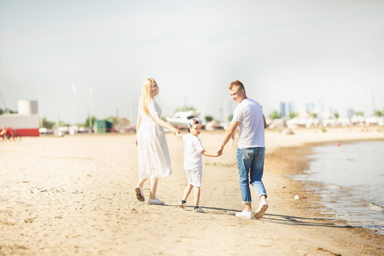 Happy family with children enjoying summer holiday at beach in Estonia, Tallinn. Back view