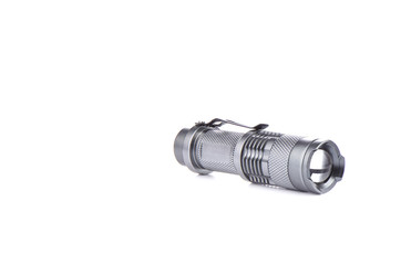 Pocket flashlight in a metal case on a white background.