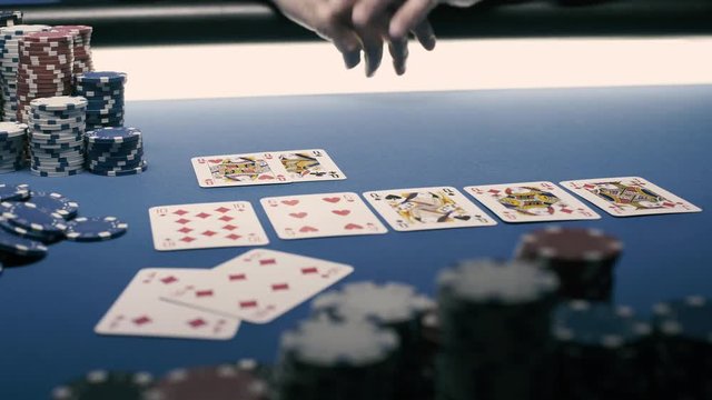 Lucky poker player revealing his cards on the table