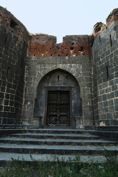 Stone masonry wall and main gate with heavy-duty door at Sardar Purandare Wada, Saswad, Pune