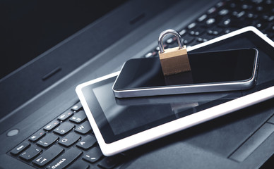 Padlock with laptop, smartphone and tablet. Internet and technology security