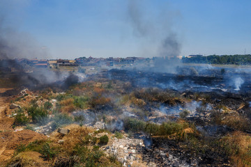 Heavy smoke in steppe. Forest and steppe fires destroy field, steppes during severe droughts. Fire, strong smoke. Blur focus due to shaking hot fire. Disaster, damage, risk to homes. View from drone