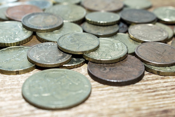 coins old rusty brass euro pile pack heap stack on a wooden background finance economy investment savings concept mock up selective focus close up