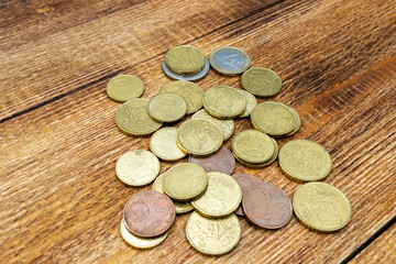 coins old rusty brass euro pile pack heap stack on a wooden background finance economy investment savings concept mock up selective focus close up