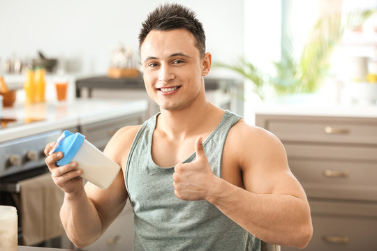 Sporty man with protein shake at home
