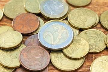 coins old rusty brass euro pile pack heap stack on a wooden background finance economy investment savings concept mock up selective focus close up