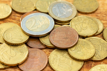 coins old rusty brass euro pile pack heap stack on a wooden background finance economy investment savings concept mock up selective focus close up