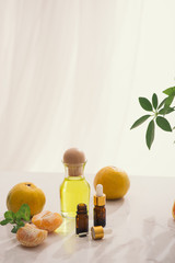 Tangerine oil on table on light background