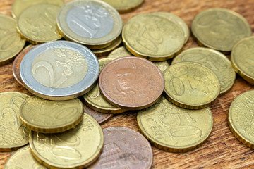 coins old rusty brass euro pile pack heap stack on a wooden background finance economy investment savings concept mock up selective focus close up