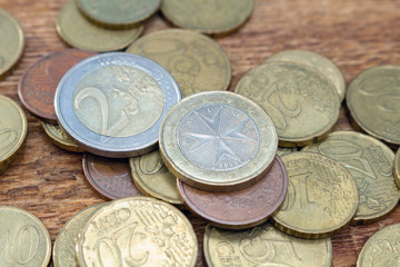 coins old rusty brass euro pile pack heap stack on a wooden background finance economy investment savings concept mock up selective focus close up