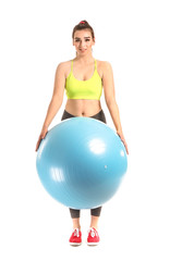 Young sporty woman with fitball on white background