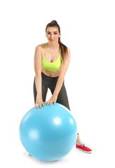Fototapeta na wymiar Young sporty woman with fitball on white background