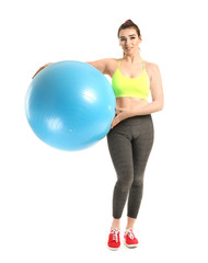 Fototapeta premium Young sporty woman with fitball on white background