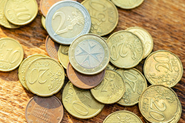 coins old rusty brass euro pile pack heap stack on a wooden background finance economy investment savings concept mock up selective focus close up