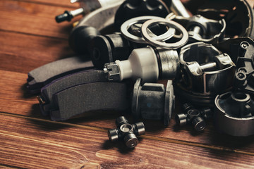 Various car parts on dark woooden background. toned photo