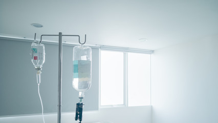 Hanging pillar and Saline solution fluid iv bag in emergency room at hospital.right copy space