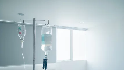 Fotobehang Hanging pillar and Saline solution fluid iv bag in emergency room at hospital.right copy space © Thasist