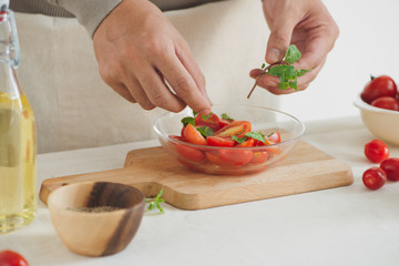 Fresh delicious salad with tomatoes. Doing fresh green salad